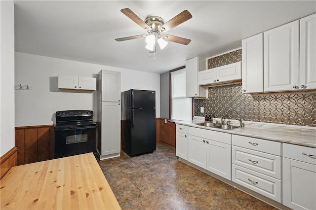 1231 19th Ave, Patterson Twp, PA 15010 - kitchen with black appliances, a sink, a ceiling fan, white cabinetry, and wainscoting