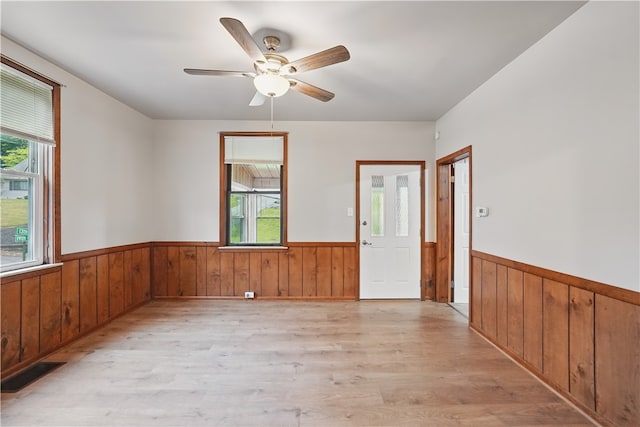 1231 19th Ave, Patterson Twp, PA 15010 - foyer entrance with wainscoting, light wood-style flooring, plenty of natural light, wood walls, and ceiling fan