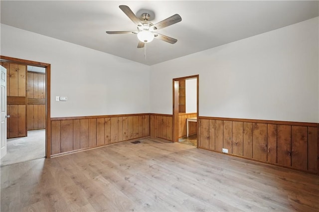 1231 19th Ave, Patterson Twp, PA 15010 - spare room featuring wood finished floors, a wainscoted wall, a ceiling fan, and wooden walls