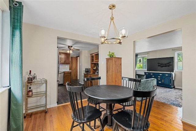534 Dendron Dr, Robinson Twp Nwa, PA 15108 - dining room featuring light wood-type flooring, ceiling fan, a chandelier, and baseboards