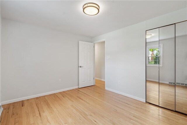 150 Dover Dr, Moon/Crescent Twp, PA 15108 - unfurnished bedroom with a closet, wood finished floors, and baseboards