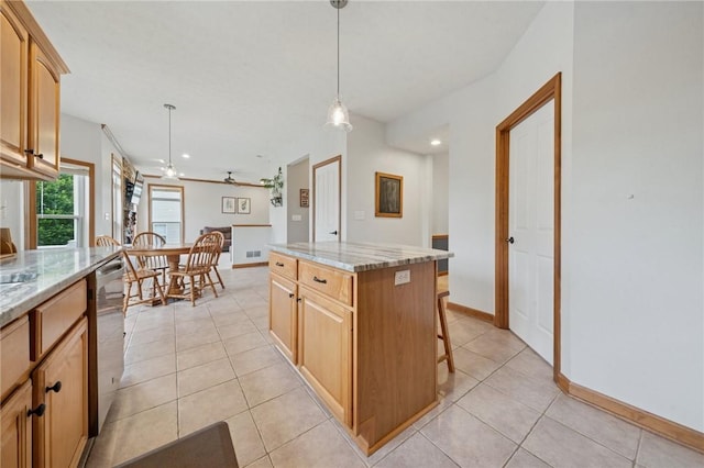 1016 Noble Pine Ct, Trafford, PA 15085 - kitchen with light tile patterned floors, a center island, pendant lighting, light stone countertops, and recessed lighting