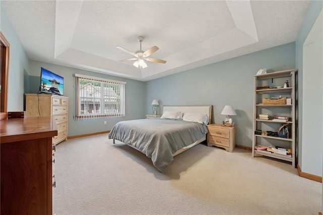 1016 Noble Pine Ct, Trafford, PA 15085 - carpeted bedroom featuring a tray ceiling, baseboards, and a ceiling fan