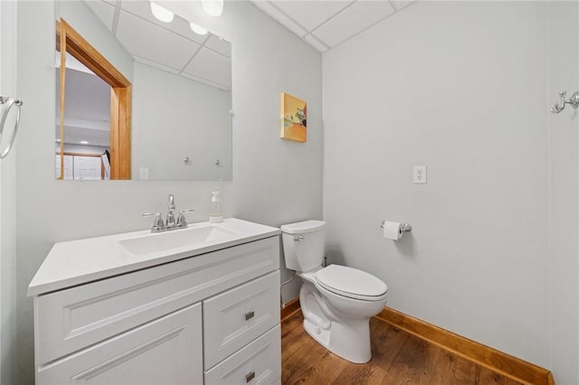1016 Noble Pine Ct, Trafford, PA 15085 - half bathroom with a drop ceiling, vanity, toilet, wood finished floors, and baseboards