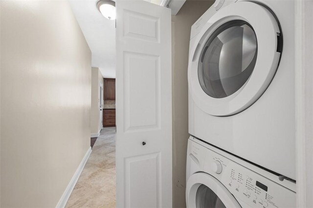 600 Camp Meeting Rd, Leet Twp, PA 15143 - laundry room with stacked washer and clothes dryer, baseboards, and light tile patterned floors