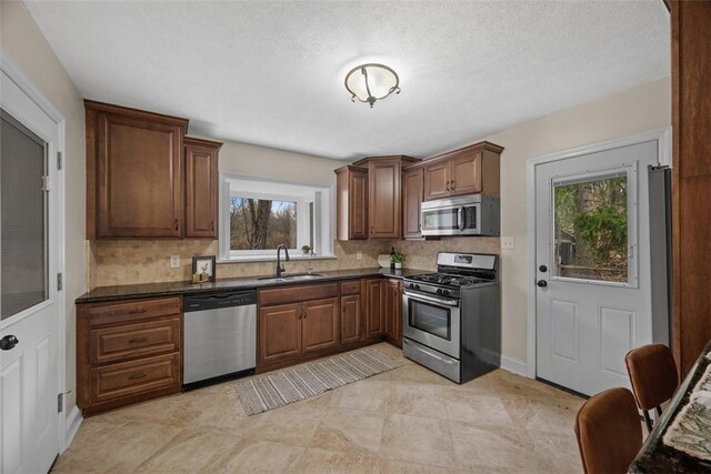 600 Camp Meeting Rd, Leet Twp, PA 15143 - kitchen featuring stainless steel appliances, a sink, dark countertops, and tasteful backsplash