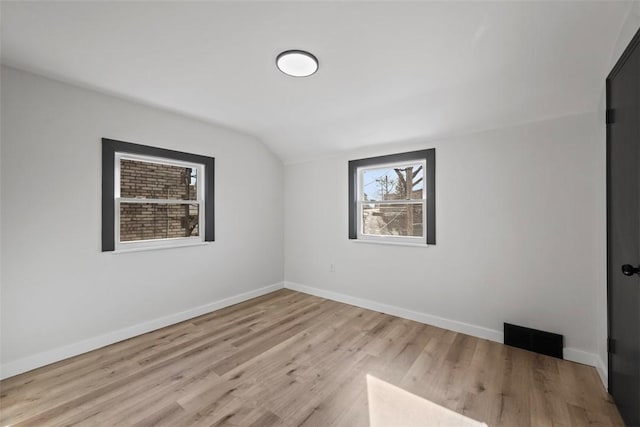 2874 Midland St, Brookline, PA 15226 - empty room featuring vaulted ceiling, wood finished floors, and baseboards