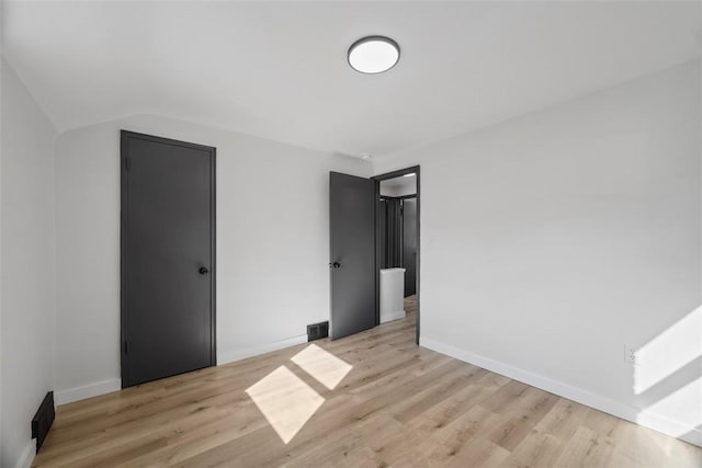 2874 Midland St, Brookline, PA 15226 - unfurnished bedroom with light wood-type flooring, lofted ceiling, and baseboards