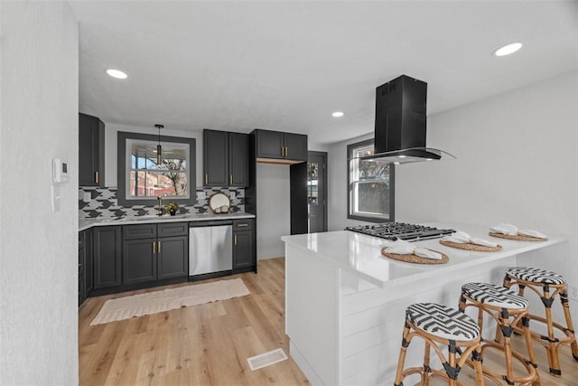 2874 Midland St, Brookline, PA 15226 - kitchen with appliances with stainless steel finishes, range hood, light countertops, a peninsula, and a sink