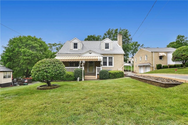 709-711 Kenny St, West Mifflin, PA 15122 - cape cod-style house with a chimney, a front lawn, an attached garage, and brick siding