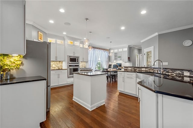 1272 Mcewen Rd, Cecil, PA 15317 - kitchen with appliances with stainless steel finishes, ornamental molding, dark countertops, a spacious island, and white cabinets
