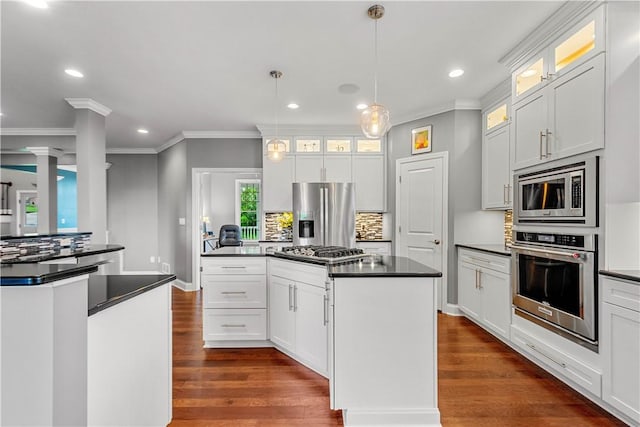 1272 Mcewen Rd, Cecil, PA 15317 - kitchen with appliances with stainless steel finishes, dark countertops, a center island, backsplash, and crown molding