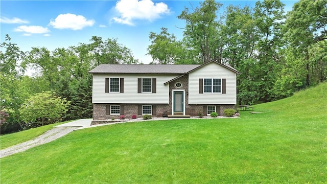 406 Maple Dr, Irwin, PA 15617 - raised ranch featuring a front lawn, brick siding, and driveway