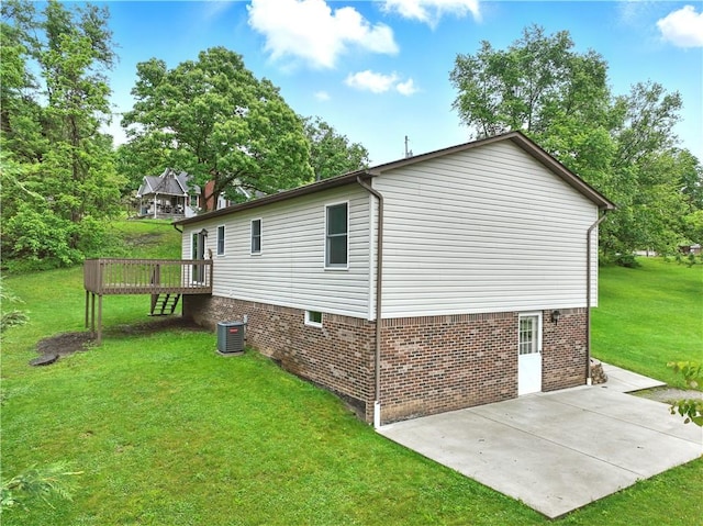 406 Maple Dr, Irwin, PA 15617 - view of side of property with a patio area, central AC, a yard, a wooden deck, and brick siding