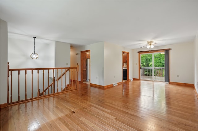 406 Maple Dr, Irwin, PA 15617 - empty room with light wood-style flooring, ceiling fan, baseboards, and a glass covered fireplace