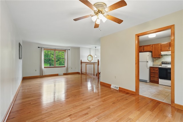 406 Maple Dr, Irwin, PA 15617 - unfurnished living room with light wood-style floors, a ceiling fan, and baseboards