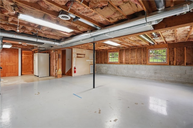 406 Maple Dr, Irwin, PA 15617 - below grade area with freestanding refrigerator and concrete block wall