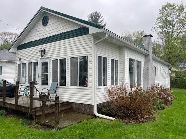 11863 Lakeview, Conneaut Lake Cra, PA 16316 - rear view of property featuring a wooden deck, a chimney, and a lawn