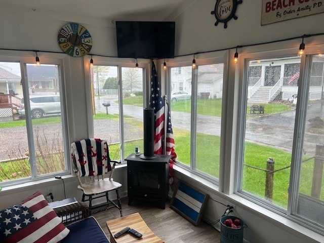 11863 Lakeview, Conneaut Lake Cra, PA 16316 - sunroom / solarium with plenty of natural light, a wood stove, and wood finished floors
