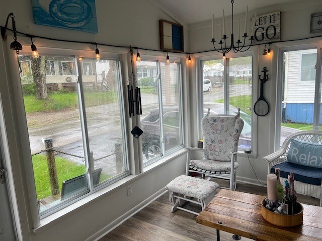 11863 Lakeview, Conneaut Lake Cra, PA 16316 - sunroom / solarium featuring healthy amount of natural light, wood finished floors, vaulted ceiling, and baseboards
