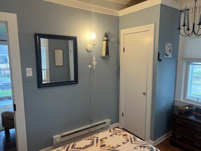 11863 Lakeview, Conneaut Lake Cra, PA 16316 - bedroom with a baseboard heating unit, a chandelier, baseboards, and wood finished floors