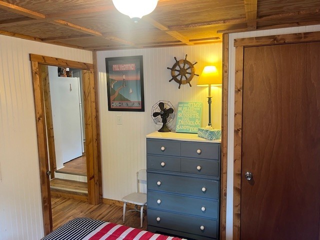 11863 Lakeview, Conneaut Lake Cra, PA 16316 - bedroom featuring wood finished floors, freestanding refrigerator, and wooden walls