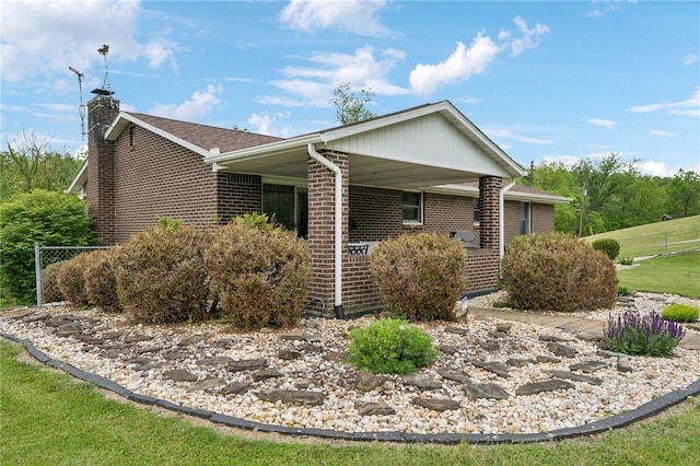 1967 Rostraver, Rostraver, PA 15012 - view of home's exterior featuring a chimney and brick siding