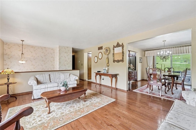 1967 Rostraver, Rostraver, PA 15012 - living area featuring a chandelier, wood finished floors, and baseboards