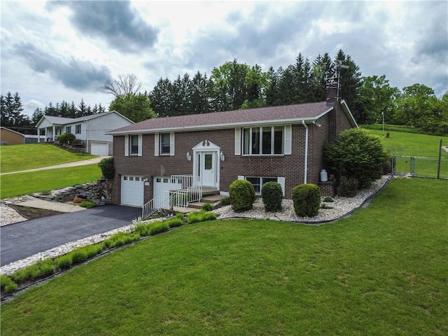 1967 Rostraver, Rostraver, PA 15012 - bi-level home featuring asphalt driveway, a garage, brick siding, and a chimney