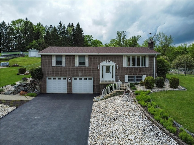 1967 Rostraver, Rostraver, PA 15012 - split foyer home with driveway, an attached garage, a front yard, brick siding, and a chimney