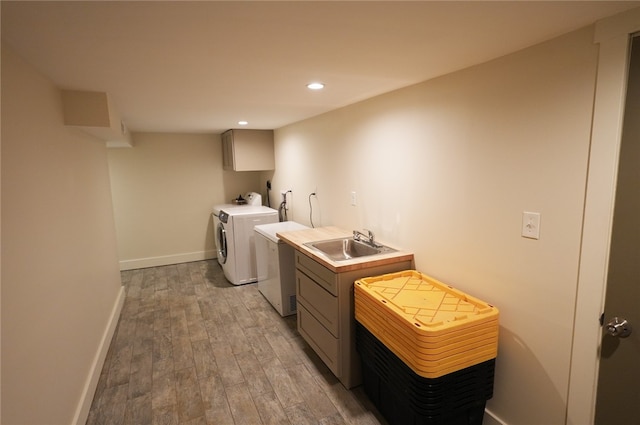 102 Green Vista Dr, Ohio Twp, PA 15237 - washroom with cabinet space, washing machine and dryer, light wood finished floors, recessed lighting, and bar with sink