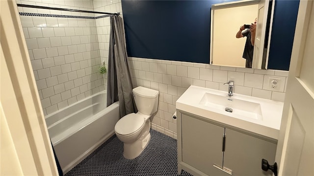 102 Green Vista Dr, Ohio Twp, PA 15237 - bathroom featuring vanity, shower / tub combo, tile patterned floors, tile walls, and a wainscoted wall