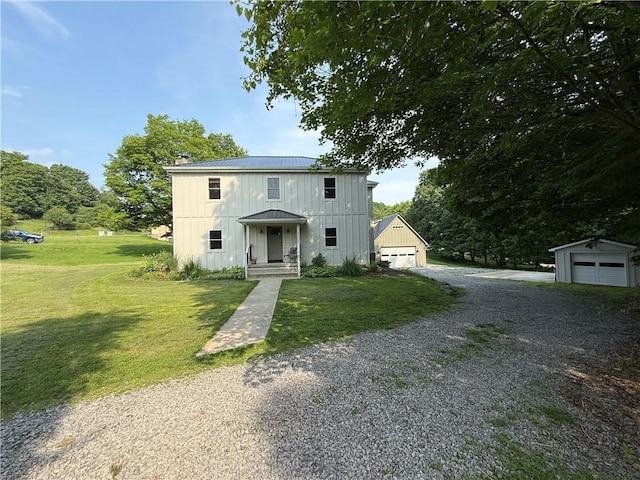 102 Green Vista Dr, Ohio Twp, PA 15237 - view of front of property featuring a detached garage, a front lawn, gravel driveway, board and batten siding, and a metal roof