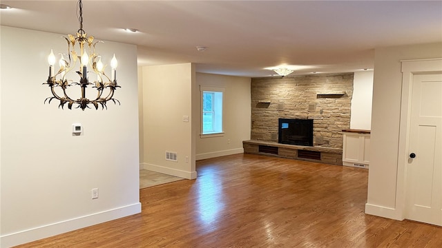 102 Green Vista Dr, Ohio Twp, PA 15237 - unfurnished living room featuring a chandelier, a fireplace, and wood finished floors