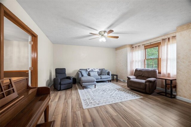 803 E Arcadia Dr, Mccandless, PA 15237 - living room with wood finished floors, ceiling fan, baseboards, and a textured ceiling