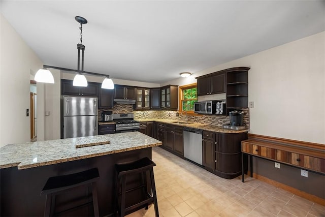 803 E Arcadia Dr, Mccandless, PA 15237 - kitchen with stainless steel appliances, a sink, tasteful backsplash, under cabinet range hood, and light stone counters