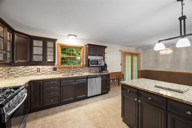 803 E Arcadia Dr, Mccandless, PA 15237 - kitchen with appliances with stainless steel finishes, a sink, dark brown cabinetry, backsplash, and light stone counters