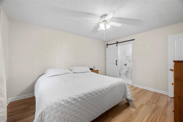 803 E Arcadia Dr, Mccandless, PA 15237 - bedroom featuring light wood-type flooring, a barn door, baseboards, and ensuite bath