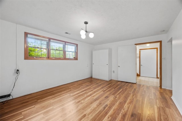 803 E Arcadia Dr, Mccandless, PA 15237 - unfurnished bedroom featuring light wood-style floors, a chandelier, and baseboards