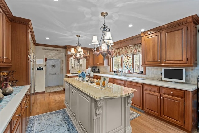 138 Presnar Dr, Neshannock Twp, PA 16105 - kitchen with a chandelier, brown cabinetry, recessed lighting, tasteful backsplash, and light wood finished floors
