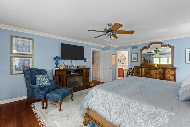 138 Presnar Dr, Neshannock Twp, PA 16105 - bedroom with baseboards, wood finished floors, crown molding, a ceiling fan, and a glass covered fireplace