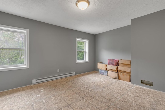677 Fairlane Blvd, New Galilee, PA 16141 - empty room featuring a baseboard heating unit and a textured ceiling