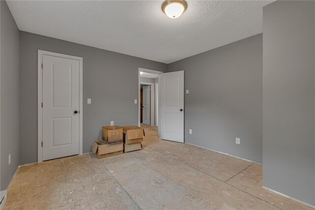 677 Fairlane Blvd, New Galilee, PA 16141 - unfurnished bedroom with a textured ceiling