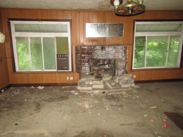 445 4th St, Freedom, PA 15042 - unfurnished living room featuring plenty of natural light, a chandelier, and a brick fireplace