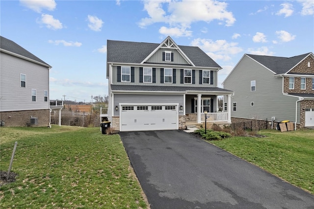 2431 Demare Dr, Bethel Park, PA 15102 - craftsman-style home with covered porch, asphalt driveway, a garage, and a front lawn