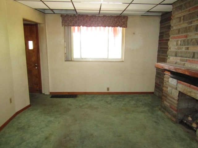 1214 1/2 3rd St, Mckees Rocks, PA 15136 - unfurnished living room featuring a drop ceiling, carpet floors, a stone fireplace, and baseboards