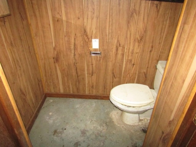 1214 1/2 3rd St, Mckees Rocks, PA 15136 - bathroom with wooden walls, concrete flooring, and toilet