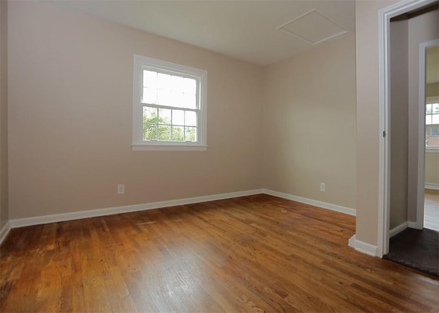 1107 Croxall Ave, Hopewell Twp Bea, PA 15001 - empty room with plenty of natural light, attic access, wood finished floors, and baseboards