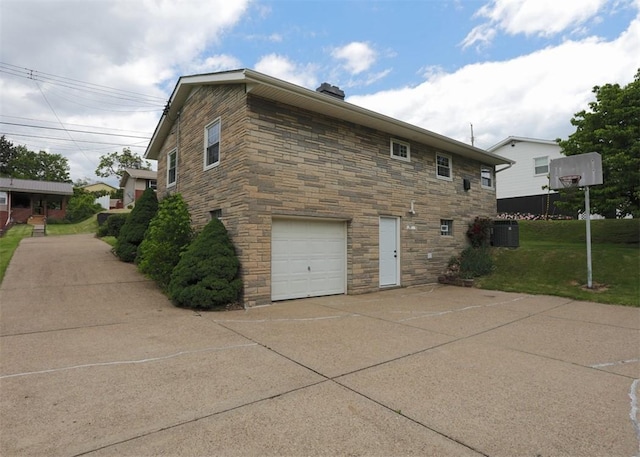 1107 Croxall Ave, Hopewell Twp Bea, PA 15001 - view of side of home with stone siding, a garage, concrete driveway, a yard, and cooling unit