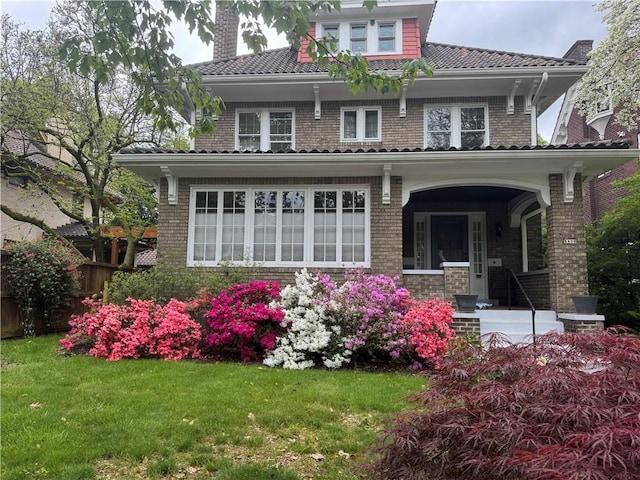 5836 Wayne Rd, Highland Park, PA 15206 - rear view of house with a yard, a chimney, a tile roof, and covered porch